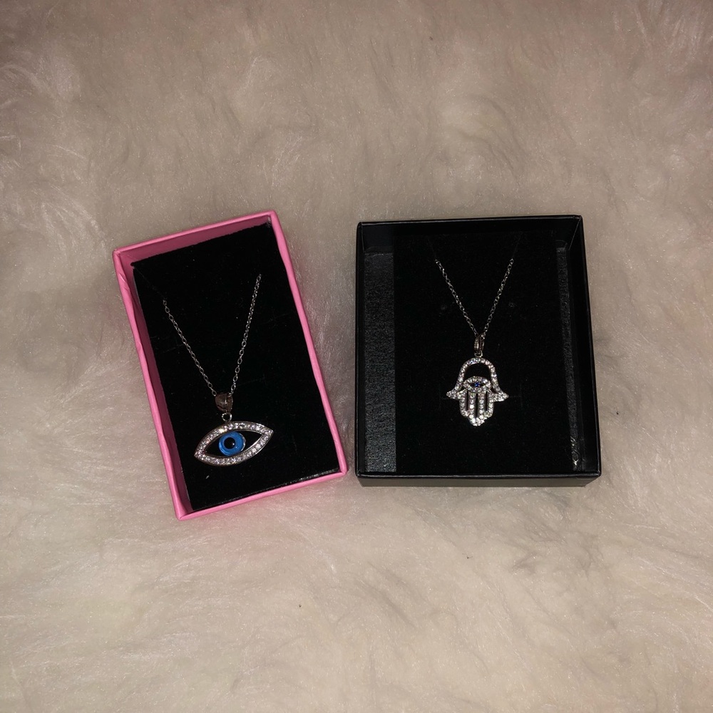 Two necklaces; one evil eye and one lucky hand